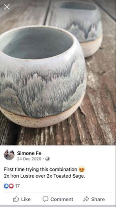 two ceramic bowls sitting on top of a wooden table next to each other with trees painted on them