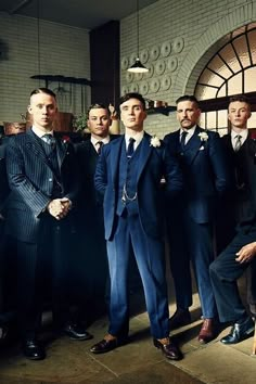 a group of men in suits standing next to each other