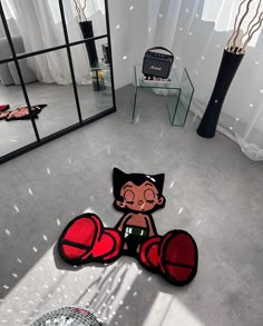 a living room with a large mirror and cartoon character rugs on the floor