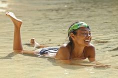 a woman laying on her stomach in the water