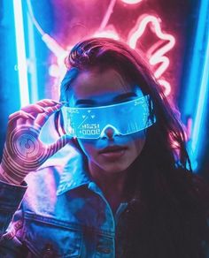 a woman wearing virtual reality glasses in front of neon lights