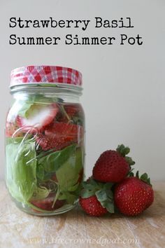 strawberries and spinach in a mason jar with text overlay reading strawberry basil summer slimmer pot