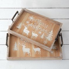 two wooden trays with christmas designs on them