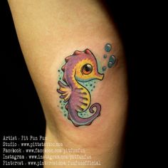 a colorful seahorse tattoo on the leg with bubbles in it's back legs