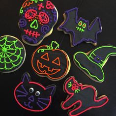 decorated halloween cookies on a table with decorations