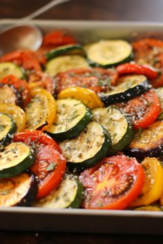 a pan filled with sliced up vegetables on top of a wooden table