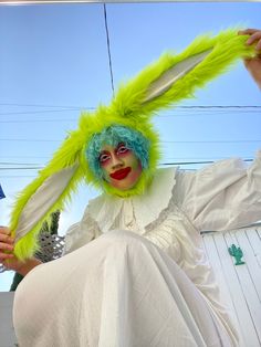 a person with green hair wearing a costume