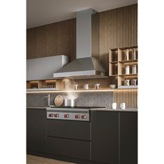 a modern kitchen with stainless steel appliances and wood paneling on the wall behind it