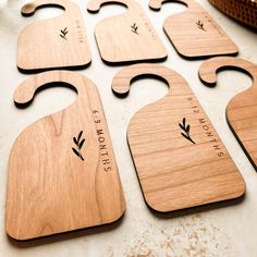 six wooden cutting boards with engraved names on them