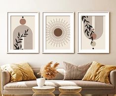 three art prints hanging on the wall above a couch in a living room with pillows