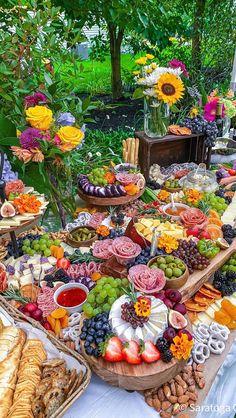 a table filled with lots of different types of food on it's trays