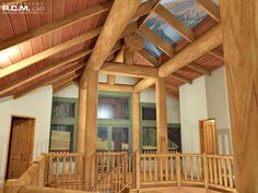 the inside of a building with wooden beams and windows