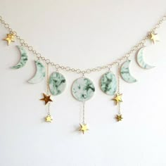 the moon and stars are hanging from the chain