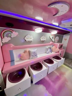 a pink and white room with lots of washers