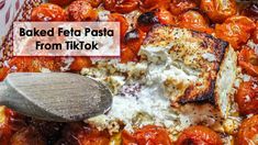 baked feta posta from tiktok in a casserole dish with a wooden spoon