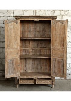 an old wooden cabinet with two open doors