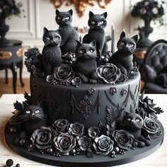 a cake decorated with black cats and roses