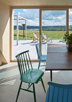 a dining room table with four chairs and a potted plant on top of it