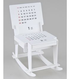 a white rocking chair with a calendar on it