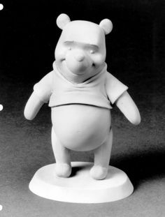 a black and white photo of a bear figurine