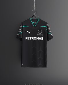 a black shirt hanging from a chain on a gray wall with the name petronas printed on it