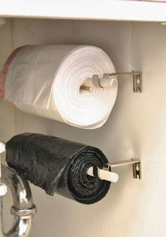 two rolls of toilet paper are hanging on the wall