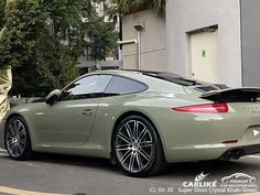 a green sports car parked in front of a building