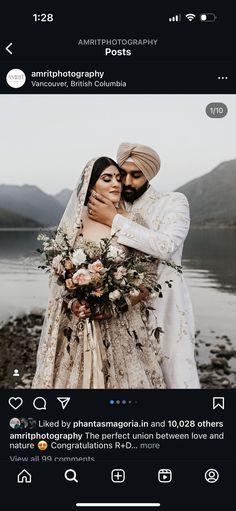 a man and woman hugging each other in front of a body of water with mountains in the background