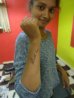 a woman with a small tattoo on her arm