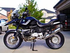 a black motorcycle parked in front of a house