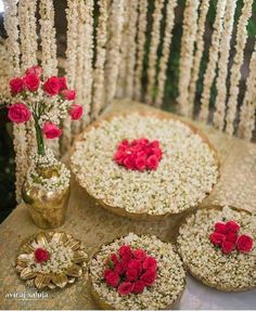 a table topped with lots of white and red flowers