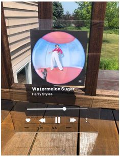 a wooden table with a sign on it that says watermelon sugar harry styles