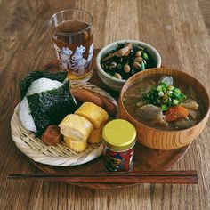 a wooden tray topped with different types of food