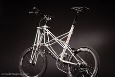 a white bicycle is shown against a black background