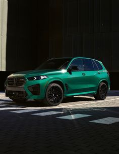 a green suv is parked on the street