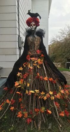 a costume made out of branches and leaves with a skeleton in the middle on top