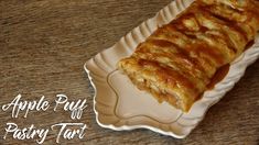 an apple puff pastry tart on a plate with the words apple puff pastry tart