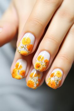 Feel the warmth of spring with these orange floral nails featuring marigolds and subtle green accents. Perfect for any springtime adventure, these nails will brighten your look. Visit nailhow.com for more spring floral nails ideas! Green Orange Nail Art, Marigold Flower Nail Art, Spring Season Nails, Marigold Nail Art, Chrysanthemum Nails, Marigold Nails, Orange Floral Nails, Spring Floral Nails, Silk Wrap Nails