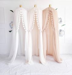 three white and pink drapes with flowers on them