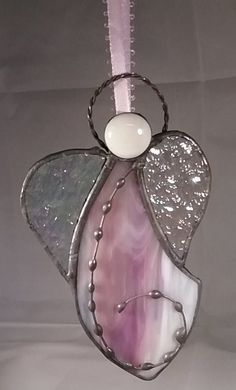 a glass angel ornament hanging from a ceiling