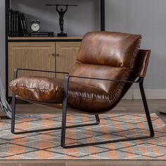 a brown leather chair sitting on top of a rug