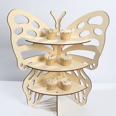 three tiered cupcake stand with butterflies on each side and cupcakes in the middle