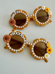 three sunglasses with flowers and the word mom written on them