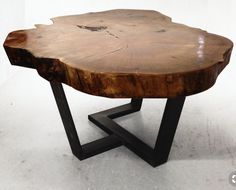 a wooden table with black metal legs on a white background