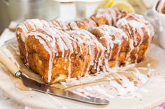 some type of pastry with icing sitting on a cutting board