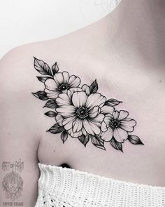 a woman's shoulder with flowers on it