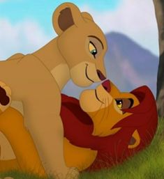 the lion and cub are playing together in the grass with each other on their backs