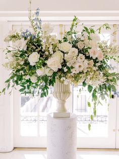 a vase filled with white flowers on top of a table