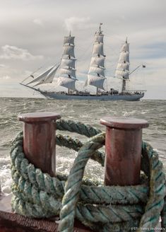 a large ship sailing in the ocean with ropes