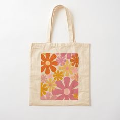 an orange and pink flowered tote bag on a white background